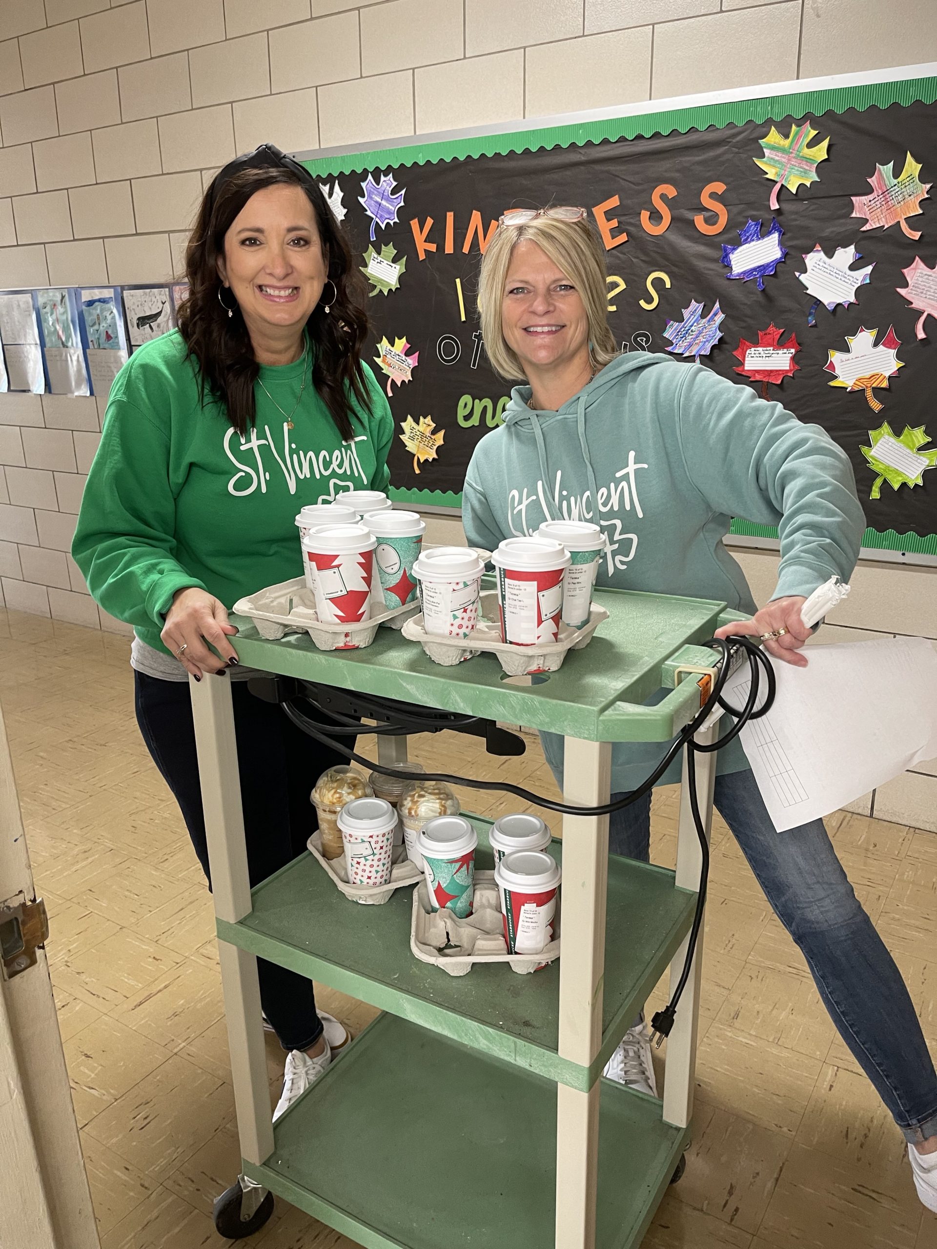 Mrs. underwood and Mrs. Kovacs delivering coffee to teachers and staff.